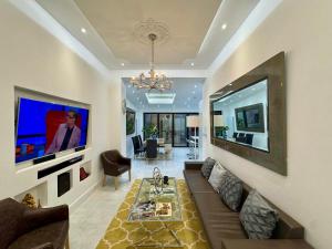 a living room with a couch and a flat screen tv at Stockwell Residences - The Eclipse Room in London