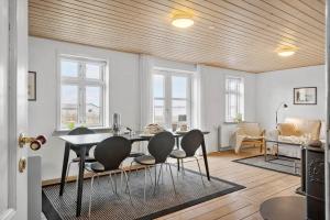 a living room with a dining table and chairs at LF11975-Struer-Havstokken-12 in Vemb