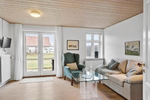 a living room with a couch and two chairs at LF11975-Struer-Havstokken-12 in Vemb