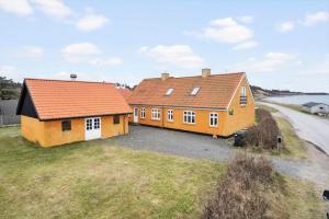 two houses with orange roofs on a grass field at LF11975-Struer-Havstokken-12 in Vemb