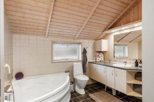a bathroom with a tub and a toilet and a sink at LF10208-Struer-Skovstien-8 in Jegind +31 photos