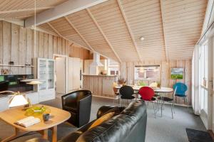 a living room with a couch and a table at LF10208-Struer-Skovstien-8 in Jegind