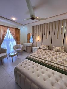 a bedroom with a large bed and a living room at apartment for rent in Islamabad +9 photos