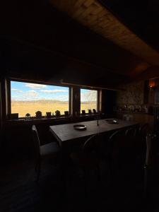 a dining room with a table and chairs and a window at Forest Lodge & Spa in Gauja National Park - Kaķukalns in Straupe +192 photos