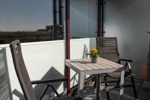 a table and two chairs on a balcony at Studio Relax in Büsum