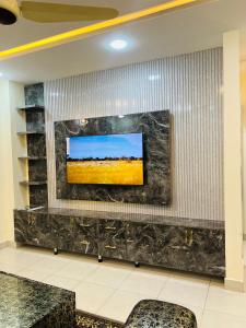 a flat screen tv on a wall in a lobby at apartment for rent in Islamabad