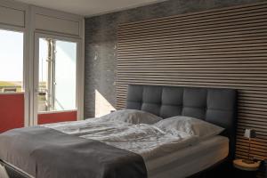 a large bed in a bedroom with a large window at Studio Relax in Büsum