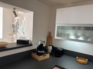 a kitchen with a counter with a coffee maker on it at La Parenthèse in Chalons en Champagne