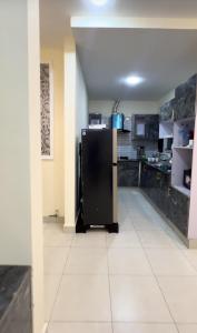 a kitchen with a black refrigerator in a room at apartment for rent in Islamabad