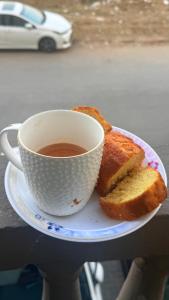a cup of coffee and two slices of bread on a plate at apartment for rent in Islamabad