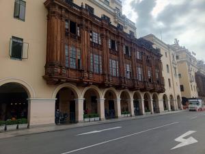 a large building with a balcony on the side of a street at Lima Centro Guest House Barrios in Lima