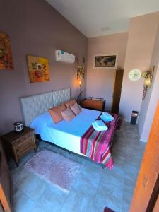 a bedroom with a bed and a table in it at Complejo Varge Norte in Alta Gracia +28 photos