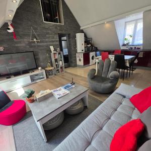 a living room with a couch and a table at Gîte Vallée de Munster 3 étoiles chez Flavie & Ludo in Muhlbach-sur-Munster