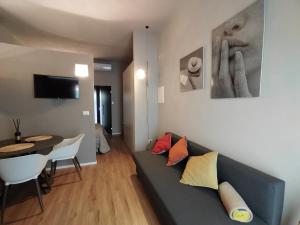 a living room with a couch and a dining room at RiDi Home 466- Suite in centro a 5 minuti dal mare in Porto SantʼElpidio