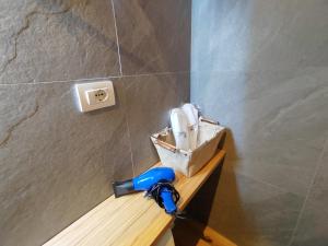 a bathroom with a hammer and a sink on a wall at RiDi Home 466- Suite in centro a 5 minuti dal mare in Porto SantʼElpidio