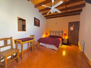 a bedroom with a bed and a ceiling fan at Hostería Don Arturo in Cachí