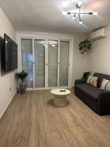 a living room with a couch and a table at Appartement ALFONSO in Salou