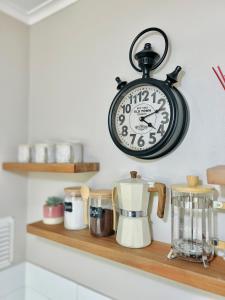 a clock hanging on a wall above a kitchen counter at Departamento Pucón in Pucón