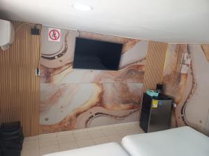 a room with a flat screen tv on a wall at Hostal Doña Betty 2 in Cartagena de Indias +1 photo