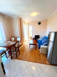 a living room with a refrigerator and a table at Dawn Park Deluxe 3 floor in Sunny Beach