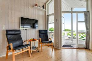 two chairs and a table in a room with a balcony at BV347-Esbjerg-V-Sjelborgdalen-22 in Esbjerg