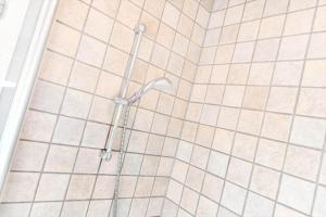 a shower in a bathroom with white tile at BV347-Esbjerg-V-Sjelborgdalen-22 in Esbjerg +31 photos
