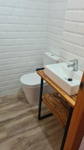 a bathroom with a white toilet and a sink at Casa Mistral in Palamós +12 photos