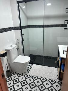 a bathroom with a toilet and a glass shower at Appartement ALFONSO in Salou +33 photos