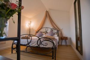 a bedroom with a bed with a canopy at Tosco Suite "Ecclesia" in Sasso dʼOmbrone