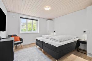 a bedroom with a bed and a desk and a window at BV262-Billum-Ho-Bugt-Vej-6 in Billum