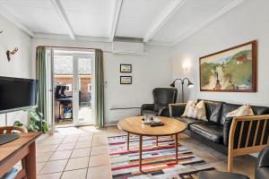 a living room with a couch and a table at BV255-Blavand-Vesterhavsparken-39 in Blåvand