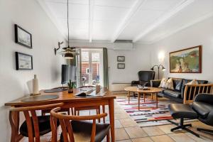 a living room with a table and a couch at BV255-Blavand-Vesterhavsparken-39 in Blåvand