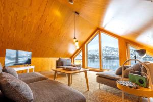 a living room with a couch and a table at Fjordview Ryten 2 Retreat in Sund