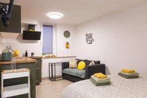 a living room with a couch and a kitchen at Lemon apartment Piran in Piran