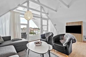 a living room with a couch and a table at BV326-Blavand-Blavandvej-4-2 in Blåvand