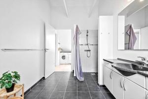 a white bathroom with a sink and a washing machine at BV326-Blavand-Blavandvej-4-2 in Blåvand +12 photos