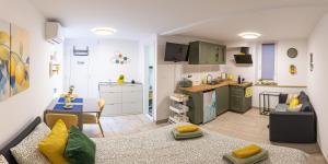 a living room with a couch and a kitchen at Lemon apartment Piran in Piran