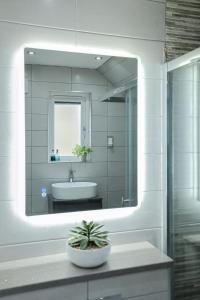 a bathroom with a large mirror and a sink at Connel House - Luxury self-catering 4-bedroom home in Connel +79 photos