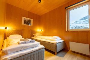 two twin beds in a room with a window at Fjordview Ryten 2 Retreat in Sund