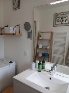 a white bathroom with a sink and a mirror at Bagatelle in Courseulles-sur-Mer +13 photos