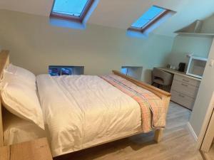 a bedroom with a bed in a room with windows at Cove Guest Accommodation in Kinvara