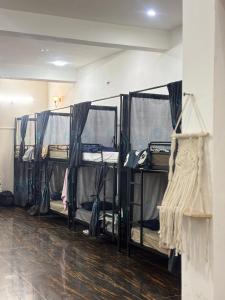 a room with a row of bunk beds at Vrinda vas Homestay in Mathura