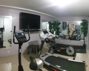 a room with a gym with a treadmill and a tv at La Julia Chambre meublée près de Paris in Corbeil-Essonnes