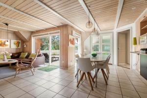 a kitchen and living room with a table and chairs at BV319-Blavand-Savmollen-14 in Blåvand
