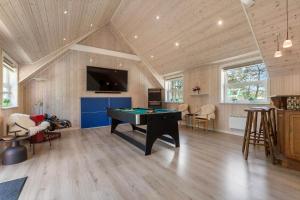 a living room with a pool table and a tv at BV319-Blavand-Savmollen-14 in Blåvand
