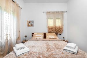 a bedroom with a large bed with two towels on it at Aquarius View in Archipolis
