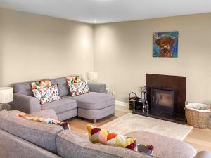 a living room with two couches and a fireplace at Stroma in Edderton