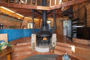 a large fireplace in a room with blue cabinets at Halfling House w/hot tub/firepit/more! in Coarsegold +38 photos