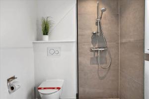 a bathroom with a shower and a toilet in it at BV208-Blavand-Strandparken-16 in Blåvand +26 photos