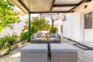 a patio with two wicker chairs and a table at Aquarius View in Archipolis